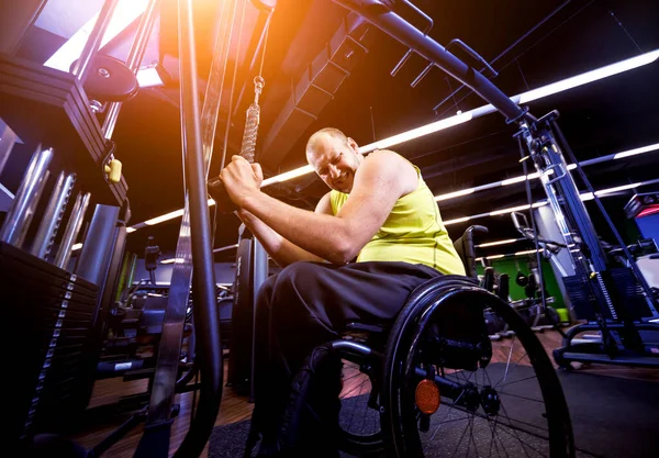 Disabled man training in the gym of rehabilitation center