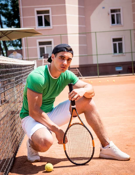Porträtt av ung atletisk man på tennisbana. — Stockfoto