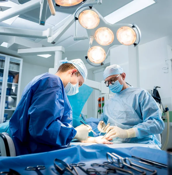 Cirujanos en quirófano tratando de salvar la mano de los pacientes. —  Fotos de Stock