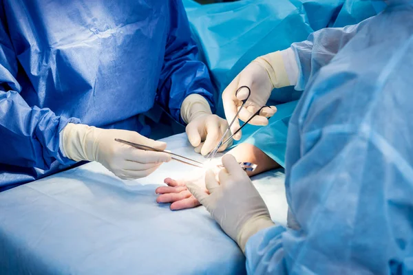 Cirujanos en quirófano tratando de salvar la mano de los pacientes. — Foto de Stock