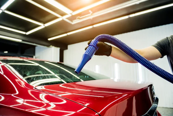 Service worker makes automatic drying of the car after washing.