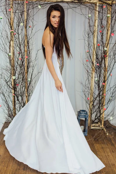 Interesting bridal modern look with crazy hairstyle and long eyelashes. Vertical studio shot.