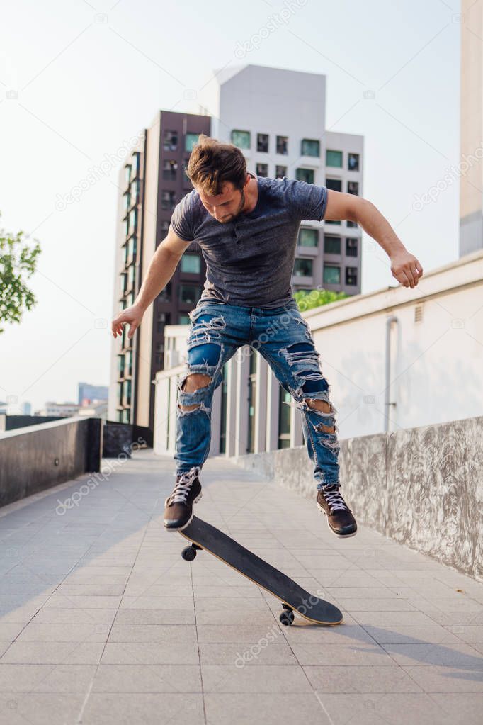 Skateboarder doing a skateboard trick ollie on the street of a city