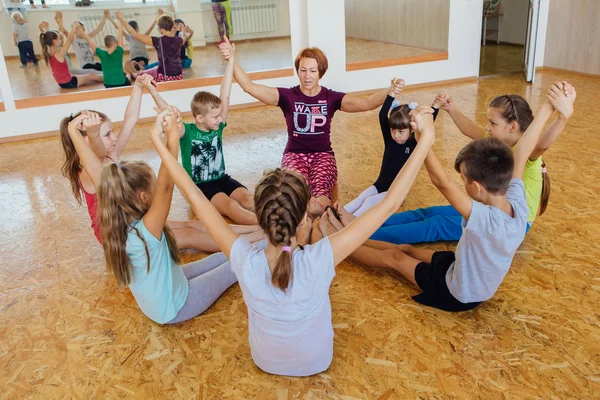 Novokuznetsk, Kemerovo bölgesi, Rusya Federasyonu - 11 Ağustos 2018: yoga sınıfına öğretmenle yoga egzersizleri yapıyor farklı yaş çocuklar.
