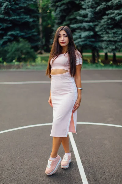 Mulher Morena Encantadora Vestida Com Vestido Rosa Posando Quadra Basquete — Fotografia de Stock