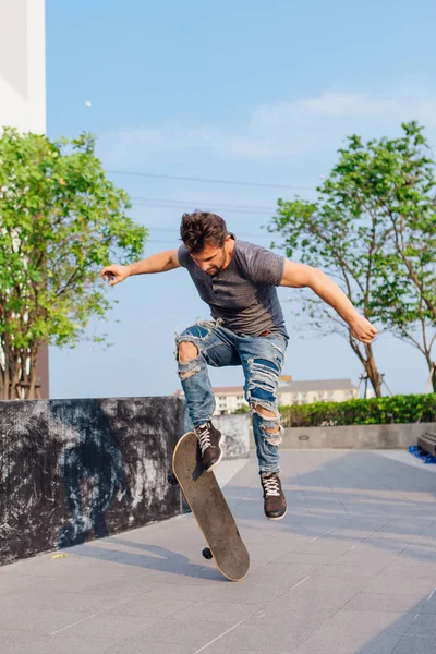 Skateboarder doing a skateboard trick ollie on the street