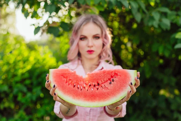 Beautiful young woman with pink hair holding watermelon — Stock Photo, Image