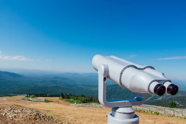 Coin operated electronic binoculars for tourists on a mountain landscape