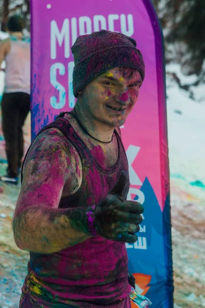Sheregesh, Kemerovo region, Russia - April 06, 2019: Young happy man painted with Holi colors — Stock Photo, Image