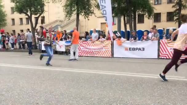 Novokuznetsk, Rusia - 09 de junio de 2019: "High Five", la quinta carrera deportiva masiva entre personas de diferentes edades. La gente está corriendo en una carrera masiva — Vídeo de stock