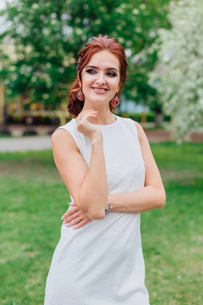 Mujer encantadora vistiendo hermoso vestido blanco bajo el manzano —  Fotos de Stock