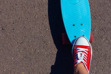 Ayak ve mavi kuruş kaymak kurulu pembe tekerlekli yakın çekim.