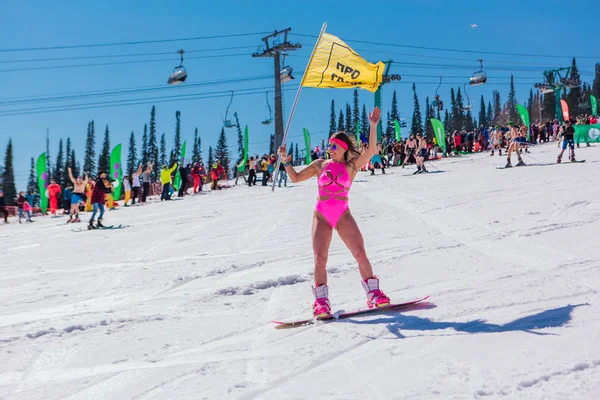 Sheregesh, Kemerovo region, Russia - April 13, 2019: Young happy pretty woman dressed in bikini with snowboard. — Stock Photo, Image