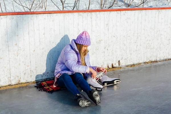 Krásná mladá žena sedí na ledovém prstenu a tkaničky — Stock fotografie