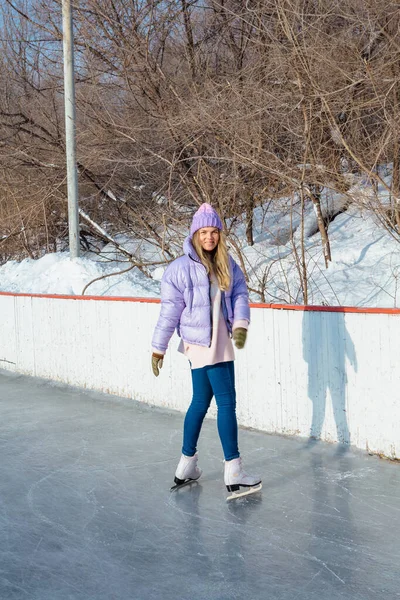 Belle jeune femme avec des patins à glace sur la patinoire . — Photo