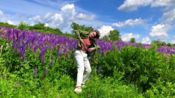 Vysoký pohledný muž tančí na lupě květiny pole — Stock video