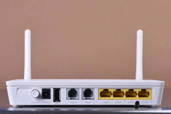 Wireless network router on brown background