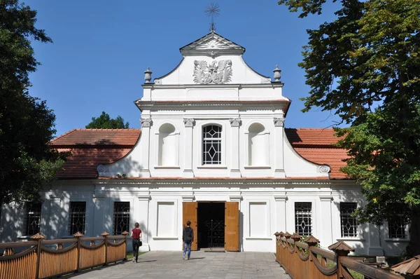 Tourists going to the baroque church, Zwierzyniec near Zamosc Poland, travel destination