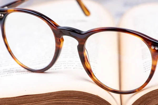 Vintage reading glasses on opened book