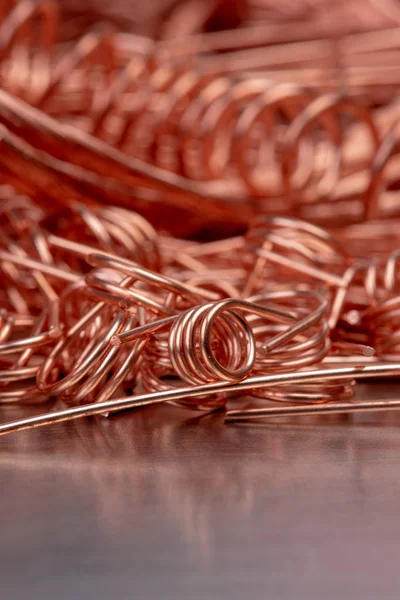 Scrap copper wire on metallic surface, raw materials metals industry and stock market concept
