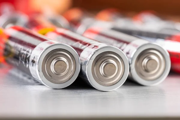 Macro Alkaline Batteries Lying Metal Table Blurred Energetic Background — Stock Photo, Image