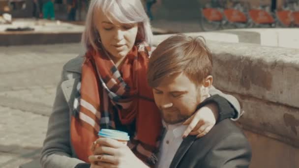 Young man gives a cup of coffee to his girlfriend — Stock Video