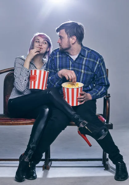 a Young couple watching movie. They are worried