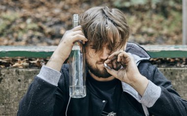 Bir bardak votka tutan adam kapatın. Sarhoş gençler. (alkolizm, ağrı, yazık, umutsuzluk, bağımlılık kavramı toplumsal sorun)