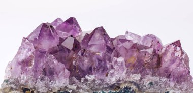 Purple rough Amethyst quartz crystals geode on white background. clipart