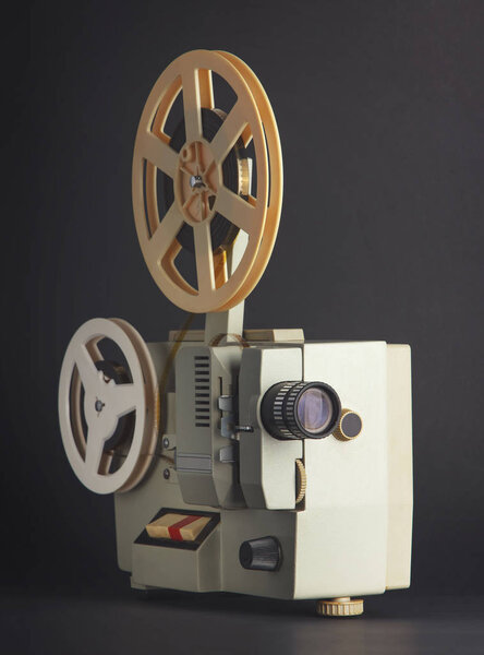 Old cinema projector isolated on black background