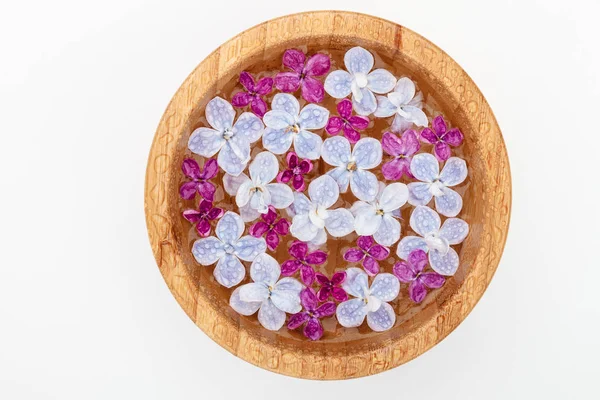 Lilac flowers in a bamboo bowl — Stock Photo, Image