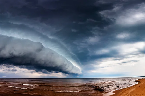 Huge Dramatic Wide Dark Storm Clouds over sea. Panoramic montage from 19 images
