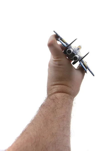 air fighter toy in human hand isolated on the white background