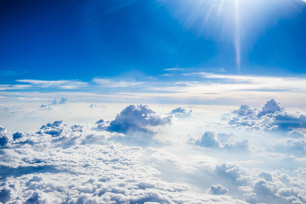 Clouds and sky as seen through window of an aircraft