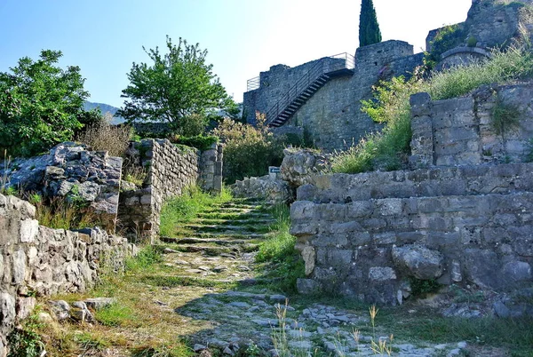 Ancient street in the old city. Fortress in the old town of Bar in Montenegro on a sunny summer day. Very visited place by tourists.