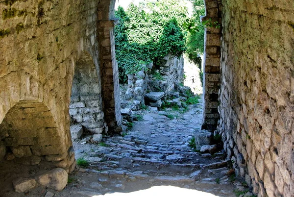 Ancient street in the old city. Fortress in the old town of Bar in Montenegro on a sunny summer day. Very visited place by tourists.