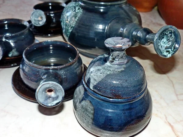 Ceramic coffee service. Latgalian ceramics. Folk craft Latvia. Traditionally, the products are painted with restrained, earthy shades. Selective focus.