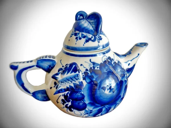 Teapot in Russian traditional Gzhel style. Gzhel - Russian folk craft of ceramics and production porcelain and a kind of Russian folk painting. Background blur, selective focus