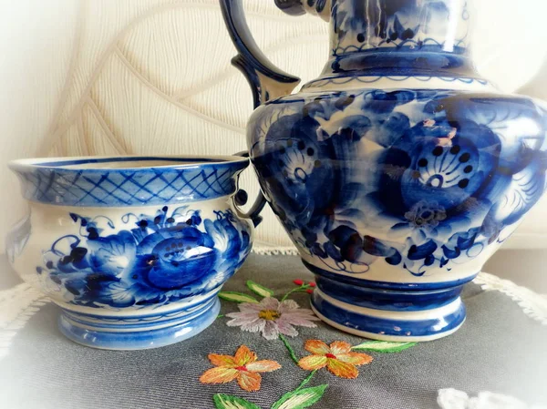 Teapot and teacup in Russian traditional Gzhel style. Gzhel-Russian folk craft of ceramics and production porcelain and a kind of Russian folk painting. Background blur, selective focus