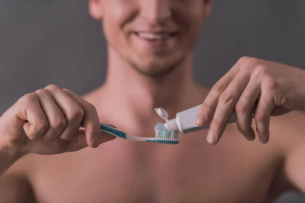 Skadrowana Przystojny Młody Mężczyzna Stosowanie Pasty Zębów Szczoteczkę Zębów Uśmiechnięty — Zdjęcie stockowe