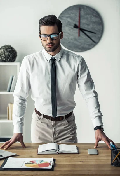 Stilig Affärsman Glasögon Tittar Kameran Stående Sin Arbetsplats Kontoret — Stockfoto