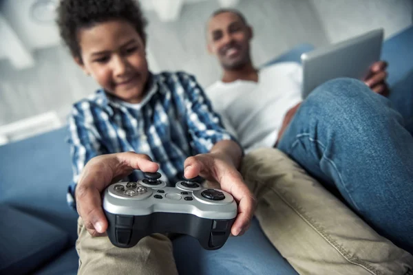 Afro American Father Son Casual Clothes Using Gadgets Sitting Couch — Stock Photo, Image