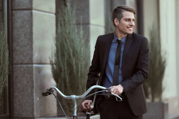 Businessman with bicycle — Stock Photo, Image