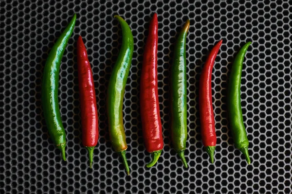 Chilli hot red and green close-up on a dark background from above — Stock Photo, Image