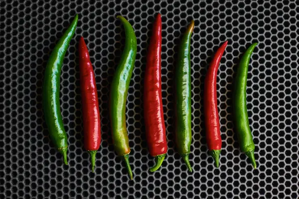 Chilli hot red and green close-up on a dark background from above — Stock Photo, Image