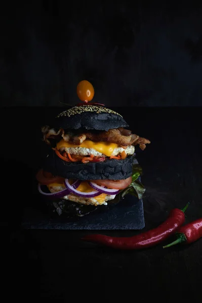 Delicious burger on a dark background filmed vertically
