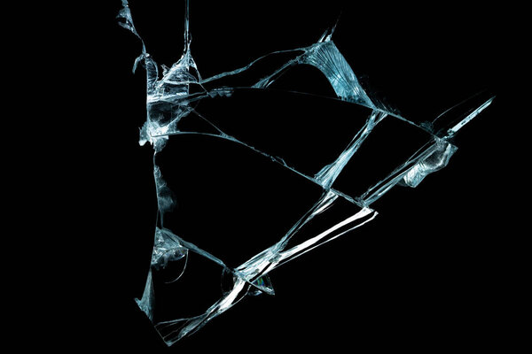 broken mirror glass on a black background in cracks in the form of an isolated image abstraction