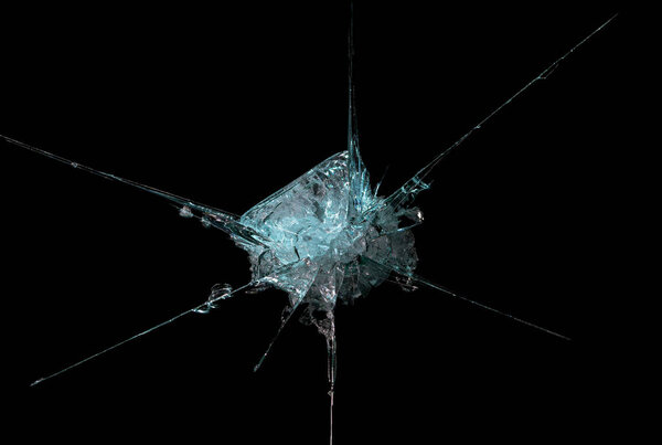 broken mirror glass on a black background in cracks in the form of an isolated image abstraction