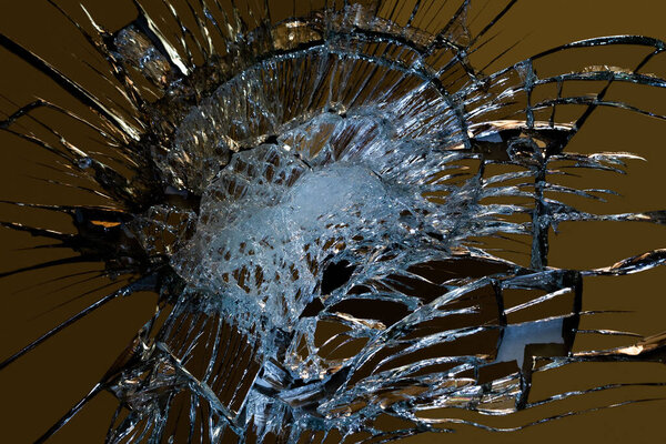 broken mirror glass on a colored and black background in cracks in the form of an isolated image abstraction