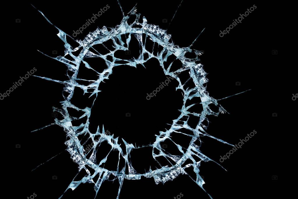 Pattern from the impact of a broken mirror and glass on a black background in cracks in the form of an isolated image abstraction